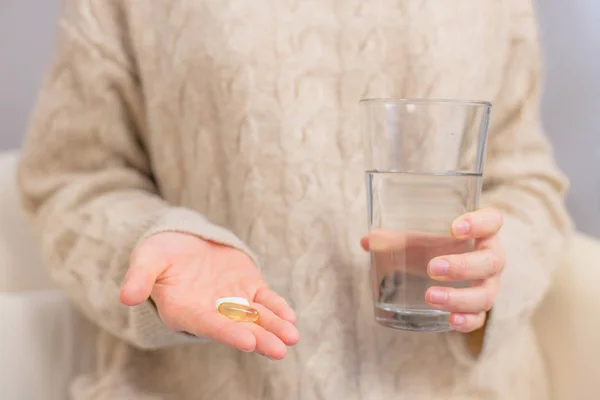 Open mouth holding medicine pill on tongue. — Stock Photo © flisakd #163093006